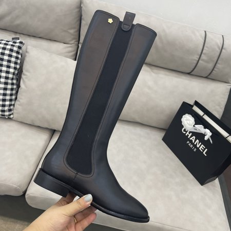 Chanel Knight s metal camellia logo on the back of the boot